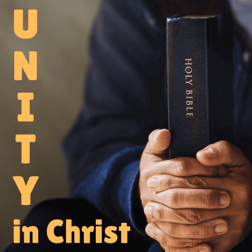 unity in christ is unity in biblical beliefs. man holing Bible in hands